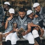 Baseball, sport and phone with a team of men on a bench after training, practice or a game. Teamwor