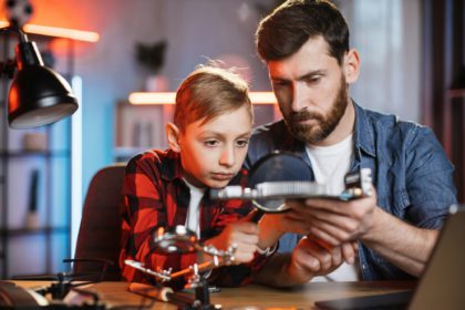 Man with boy examining problem of non working display card