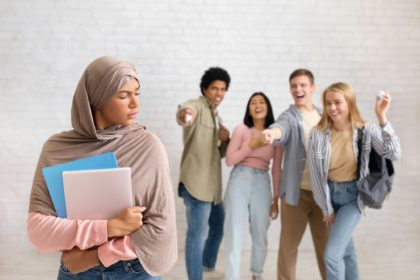 Upset lonely woman suffering from bullying and racial discrimination